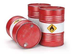 Red metal oil barrels isolated on white background. Oil, gas and